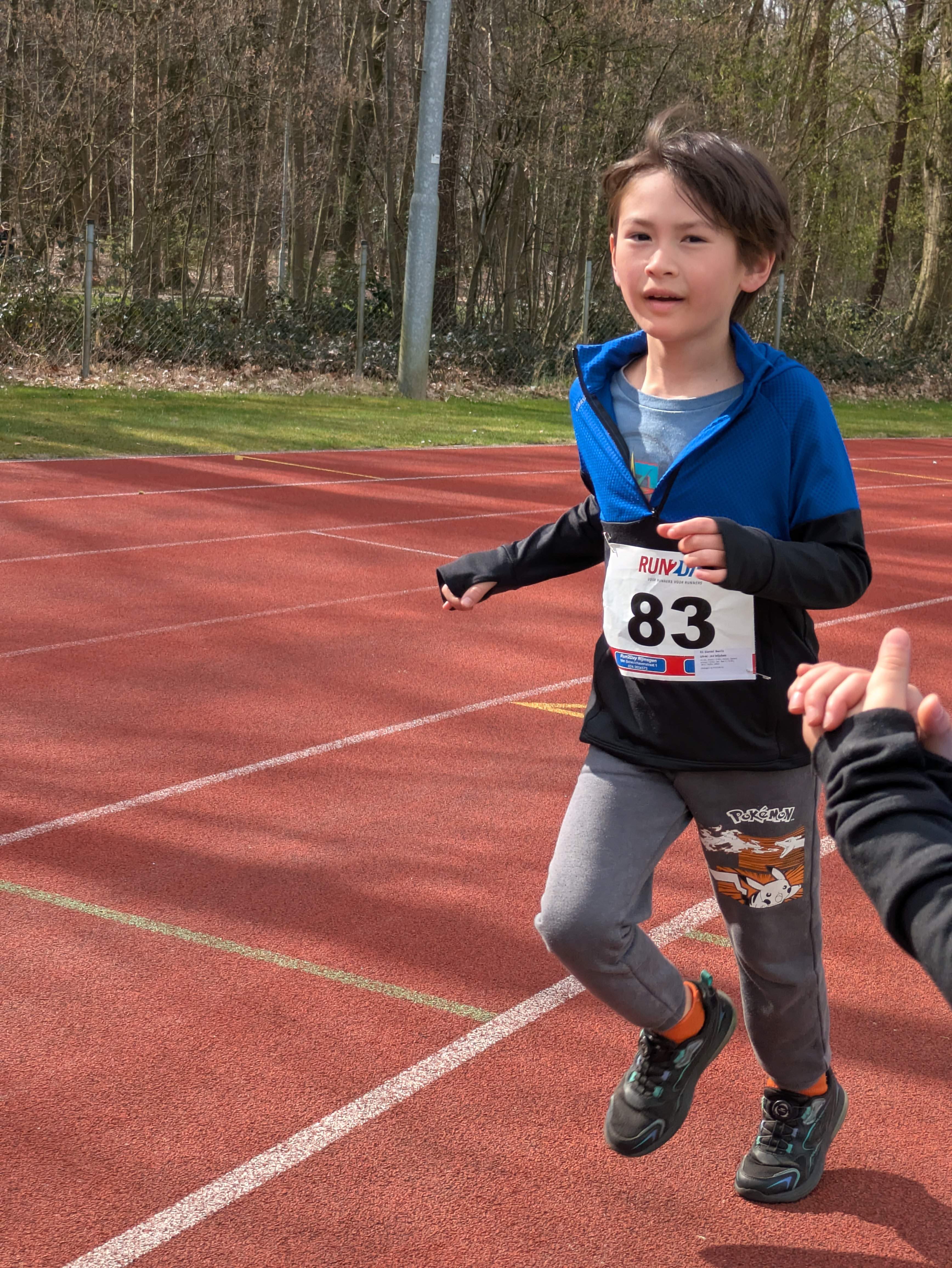 Daniel running in a race event, wearing number 83